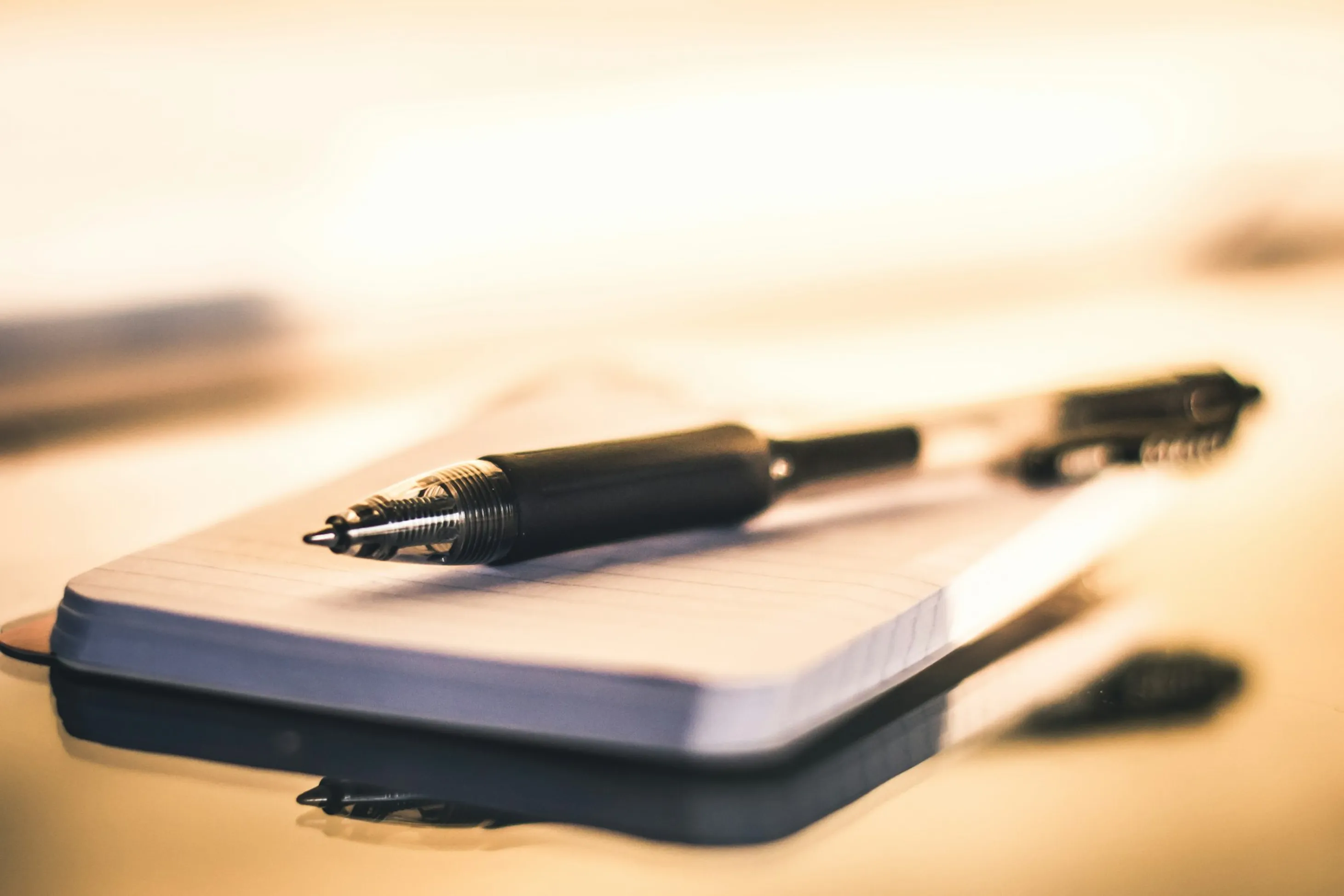 A pen ontop of a notebook indicating the importance of keeping notes